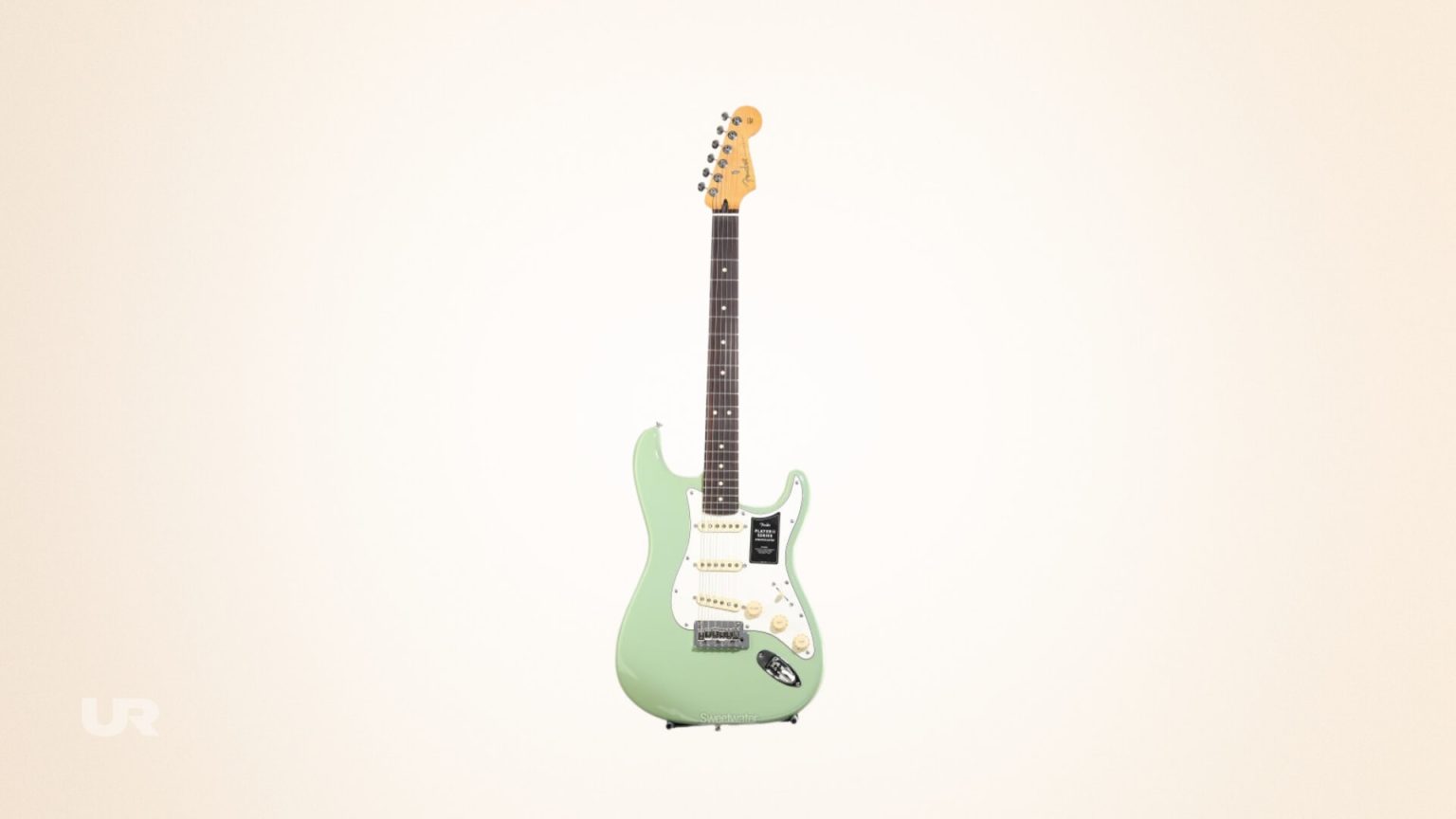 Fender Player II Stratocaster in birch green electric guitar isolated on a light yellow gold gradient background
